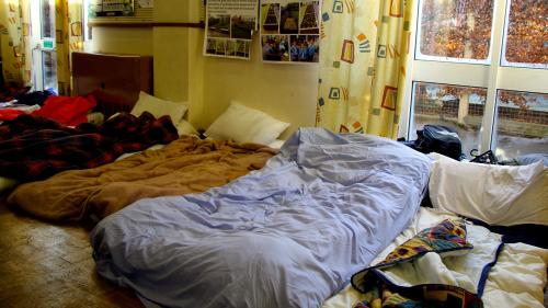 Beds on floor in homeless hostel. Photo by Becks Hobbs Photography